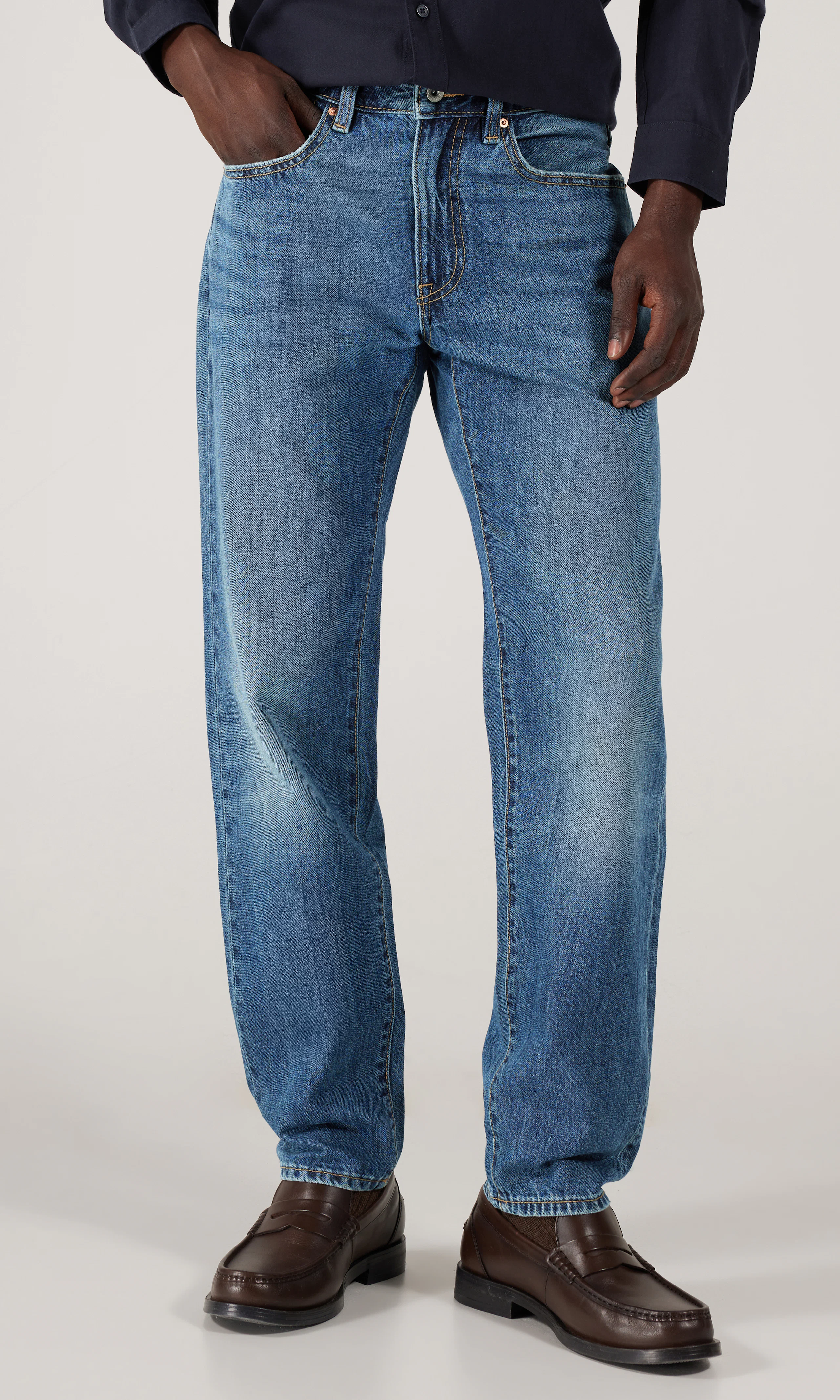 Tapered Jeans. Front. Model.