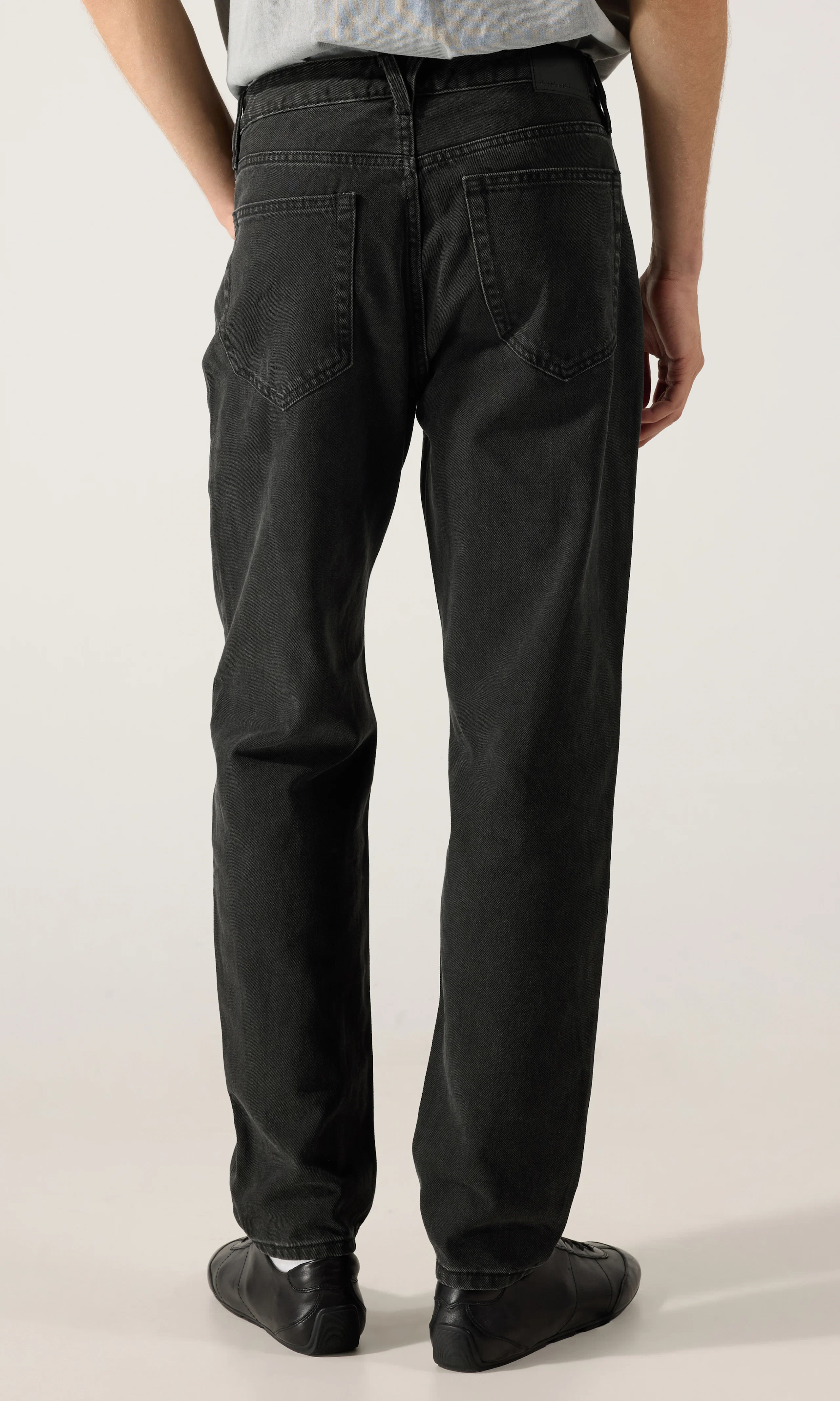 Tapered Jeans. Back. Model.