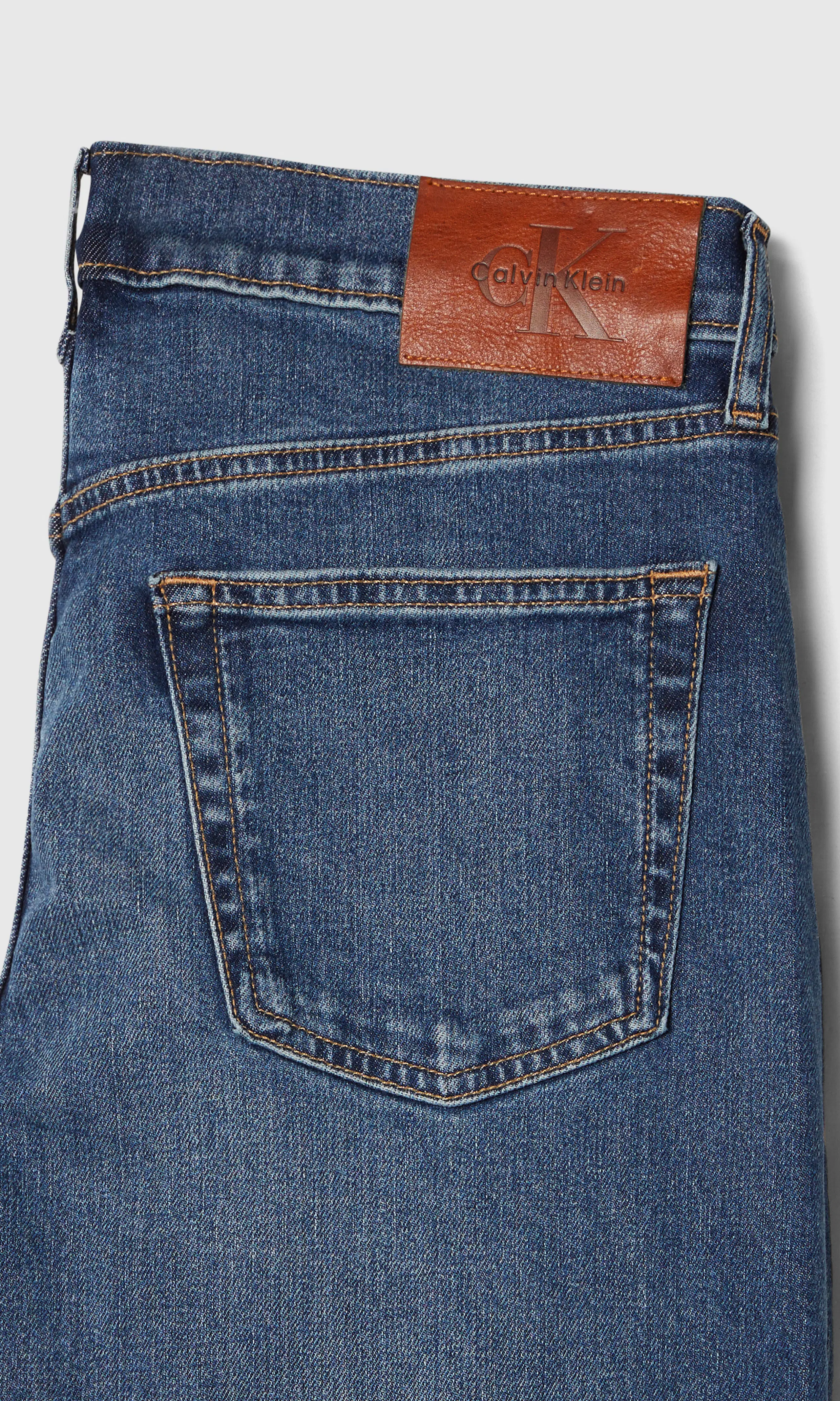 Slim Tapered Medium Blå Jeans. Detail 1. Flat.